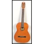 A 20th Century Hokada classical acoustic guitar having inlaid decoration to the sound hole and