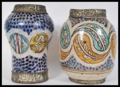 Two 20th Century Moroccan / Moorish pottery vases to include a bulbous vase with hand painted