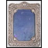 An early 20th Century Late Victorian hallmarked silver photo photograph frame of ornate Rococo