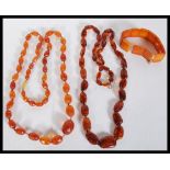 Two believed amber graduating bead prayer necklaces along with a believed amber panel bracelet.