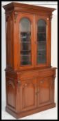 A good quality Victorian style mahogany library bookcase cabinet raised on plinth base with arched
