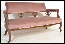 An early 20th Century Edwardian mahogany two seater salon sofa, the open back with open fretwork