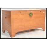 A 20th Century large chamfer wood blanket box storage chest trunk coffer having carved detailing and