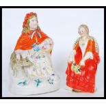 Two 19th Century ceramic figures to include a seated lady with a dog and another seated lady with