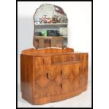 A 1930's Art Deco figured walnut cloud form swing mirror back dressing chest table fitted with an