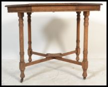 A late 19th Century Victorian octagonal oak centre table, raised on turned supports united by