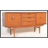 A retro 20th Century Danish inspired teak sideboard - credenza of small proportions, having a