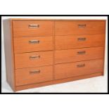 A retro 20th Century teak wood chest of drawers, the chest with a a configuration of eight drawers