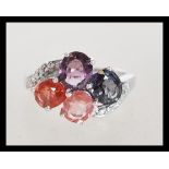 A sterling silver 925 large ring of crossover form having four large faceted stones with white stone