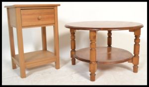 An antique style country pine coffee table raised on block supports along with a similar country