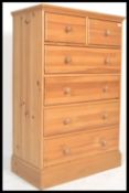 An antique style country pine two over four chest of drawers. The bank of drawers raised on plinth