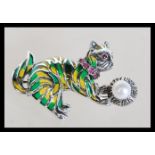 A sterling silver plique a jour brooch in the form of a cat playing with a ball having marcasite,