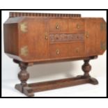 A 1930's Art Deco oak sideboard dresser raised sphere turned supports united by stretchers and