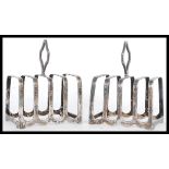 A pair of early 20th Century hallmarked silver toast racks by Walker and Hall bearing Chester