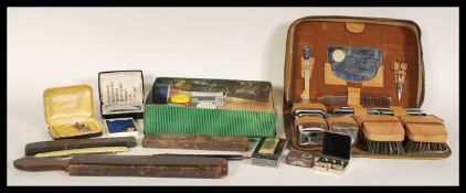 A selection 20th Century vintage gentleman's grooming set within a leather case including clothes