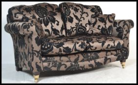 A contemporary large scroll arm two seater sofa, possibly by Multiyork, upholstered in a satin