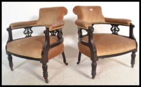 A pair of early 20th Century Edwardian tub shaped elbow chairs / armchairs upholstered overstuffed