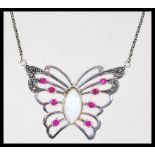 A sterling silver Cz and central paneled opal pendant necklace in the form of a butterfly. Weighs 13