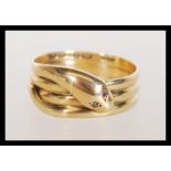 A hallmarked 18ct gold ring in the form of a snake with white stone eyes. Hallmarked Birmingham.