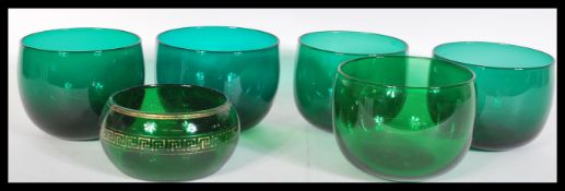 A group of six 18th Century Georgian green glass bowls to include a near set of five and a smaller