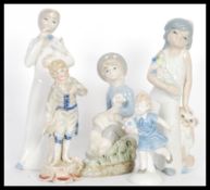 In the style of Lladro - A selection of ceramic figurines to include a girl with a lamb sat on her