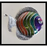 A sterling silver plique a jour brooch in the form of a fish having a red stone eye.