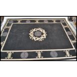 A fantastic and large 20th Century Chinese floor carpet rug having a black ground with geometric