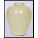 A Chinese monochrome baluster vase of globular squat form having famille Jaune decoration with short