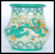 A 1930's Charlotte Rhead tube lined vase of squat form hand painted with the Manchu dragon pattern