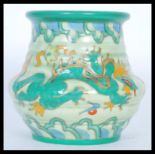 A 1930's Charlotte Rhead tube lined vase of squat form hand painted with the Manchu dragon pattern