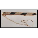 A hallmarked 9ct gold gentleman's tie clip, engine turned, makers mark for G & S, 6 cm in length and