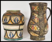 Two 20th Century Moroccan / Moorish pottery vases to include a wire mounted vase having hand painted