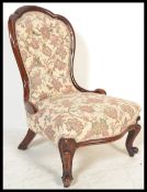 A 19th Century Victorian button backed mahogany nursing chair having carved shaped cabriole legs,