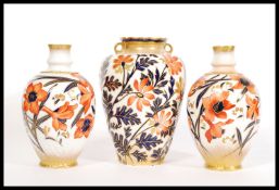 A pair of George Jones ceramic Faience vases in co