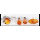 A collection of sterling silver and amber effect jewellery to include a pair of large drop earrings,