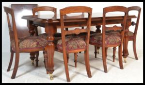 An antique Victorian 19th Century style mahogany extendable dining table of canted rectangular