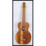 A scratch built Ukulele having inlaid dark wood in a checker board pattern to the sound hole and