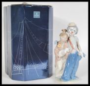 A Lladro ceramic figure depicting a clown and a boy entitled Forever Pals 07686. Complete in