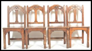 A set of four late 19th Century oak church chairs raised on square legs, with gothic chamfered