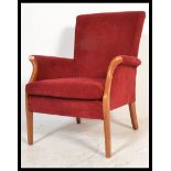 A 20th Century retro Parker Knoll fireside / lounge armchair, beech wood show frame raised on