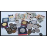 A collection of coins and notes dating from the early 20th Century to include a selection of Queen