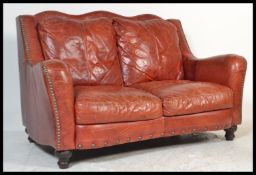A contemporary 20th Century two seater leather Chesterfield style sofa, believed to be from