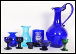 A collection of Bristol blue glass and others to include a large Bristol Blue glass ewer / water jug