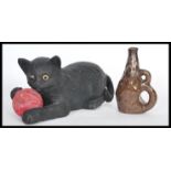 A Bretby figurine in the form of a cat with a ball of pink yarn no. 1618 and a smaller art pottery