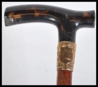 A 19th Century Victorian walking stick cane having a tapering bamboo shaft with shaped tortoiseshell