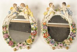 A PAIR OF GERMAN SITZENDORF PORCELAIN CHERUB BARBOLA MIRRORS