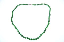 A green jadeite and diamond necklace. The necklace having round jadeite beads, approx 4-5mm, with