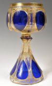 A 19TH CENTURY GERMAN BOHEMIAN BLUE CASED & GILT GLASS GOBLET