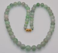 A jadeite bead necklace having screw clasp. Untreated. 97.8g.
