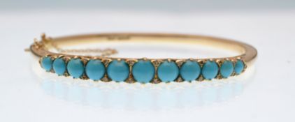 A hallmarked 14ct gold, turquoise and diamond half hoop bangle